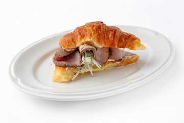 Mini sandwich with with beef tenderloin with sauce. Beautifully decorated catering banquet menu. Food snacks and appetizers for buffet. Isolated on white background