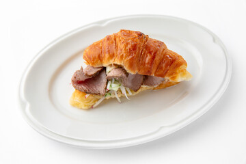 Mini sandwich with with beef tenderloin with sauce. Beautifully decorated catering banquet menu. Food snacks and appetizers for buffet. Isolated on white background