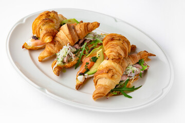 Mini sandwich with salmon, avocado, truffle oil. Beautifully decorated catering banquet menu. Food snacks and appetizers for buffet. Isolated on white background