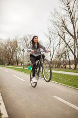 Fototapeta premium one young woman, riding bicycle Wheelie style.