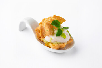 Profiterole with creamy mousse, sauce. Beautifully decorated catering banquet menu. Food snacks and appetizers for buffet. Isolated on white background