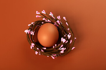 Chicken eggs in a nest on a beige background. Minimalistic Easter concert