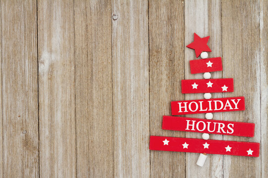 Holiday Hours sign on weathered wood