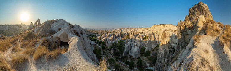 Fototapeta na wymiar The picturesque panorama of Cappadocia at sunset, amazing Turkey, Mountains and rock formation, big size image, Goreme national park, Love valley, open air museum, ancient region of Anatolia, Unesco