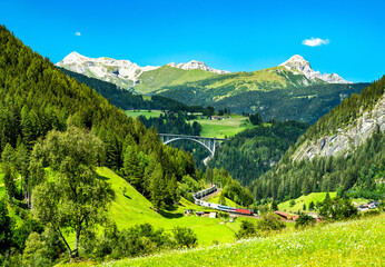 Train with trailers crossing the Alps in Austria