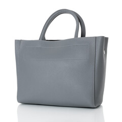 A grey grained leather tote bag for women. Model with two handles. White background