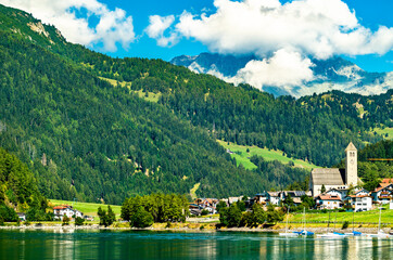 Fototapeta premium Church at Reschen am See or Resia, a village on Lake Reschen in South Tyrol, Italy