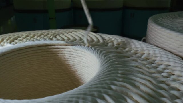 Cotton yarn production. Machinery and equipment in the workshop. Interior of industrial textile factory. 4K. close up. slow motion. 2.