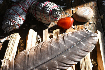 A close up image of sacred holy wood, red jasper, and reiki healing symbol. 