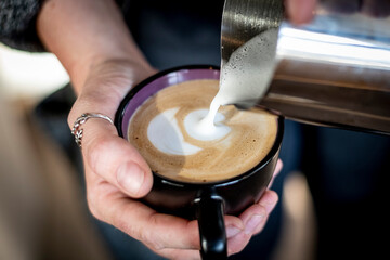 Fototapeta na wymiar Barista making a cup of coffee latte art.