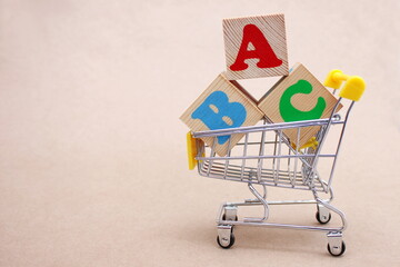 ABC blocks with English letters in a toy shopping cart. alphabet
