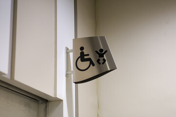 Stainless steel disabled toilet sign, wall-mounted in the mall