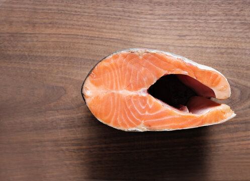 Fresh Raw Salmon Steak On Wooden Kitchen Cutting Board. Fish Menu As Omega-3 And Fatty Acids Source