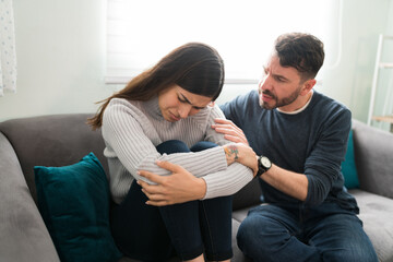 Hispanic man breaking up with his sad girlfriend