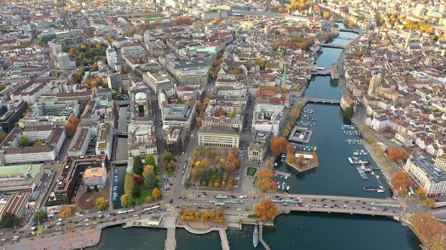 Aerial drone view of Zurich city with the old town around the Limmat river that lies next to the business and financial district and the Parade Platz in Switzerland. Shot with a forward motion