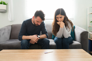 Stressed couple waiting for the results of a pregnancy test