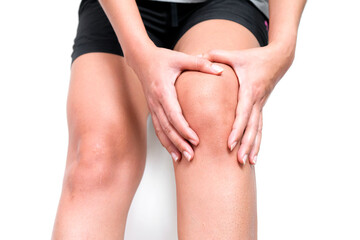 Sport man with knee pain and holding hand on her knee, on white background, healthy care and sport concept.