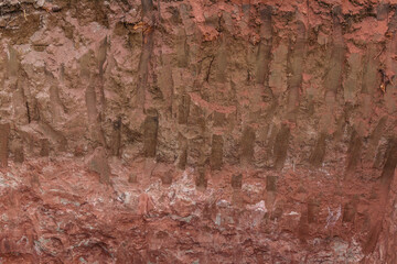 Clay surface. Colors - red, brown, white. Traces of mechanical stress.