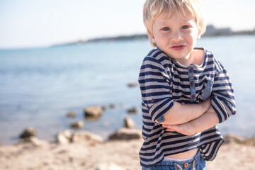 Fototapeta na wymiar Happy kid dressed straw hat and shorts rest in the beach