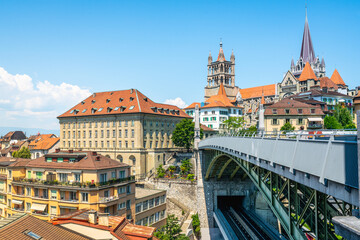 Fototapeta na wymiar Lausanne scenic cityscape with Bessieres bridge and old town panorama with the Cathedral and clear summer blue sky Lausanne Vaud Switzerland