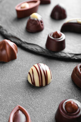 Obraz na płótnie Canvas Tasty chocolate candies on dark background