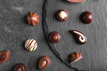 Tasty chocolate candies on dark background