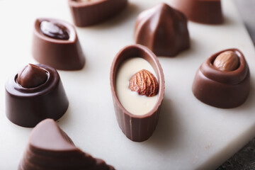 Tasty chocolate candies on board, closeup