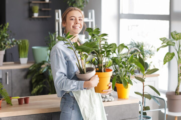 Young woman taking care of her plants at home