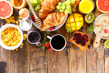 continental breakfast with coffee cup, fruit and croissant