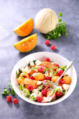 melon salad with raspberry, mozzarella and ham