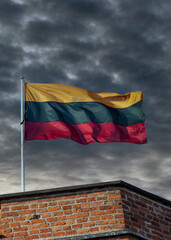 Lithuania flag on a background of cloudy sky.
