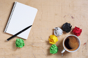 Notepad, coffee and paper balls
