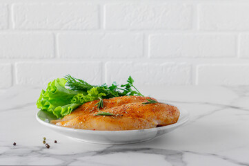 Raw chicken breasts with greens and tomatoes ready for cooking. dietary food