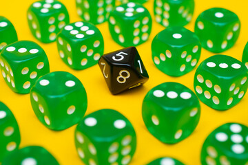 Green gaming dices pattern on yellow background and black d8 cube in the middle. Table games concept concept of role-playing games and games for the whole family at home