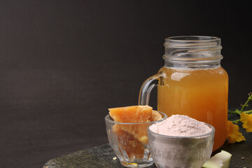 Raw Mango juice - Aam Panna or Panha in a transparent glass with whole green fruit,