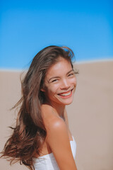 Asian model natural beauty woman portrait. Vertical headshot of smiling young girl in her 20s, without makeup. Minimal retouching for real candid look.