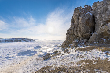 Ogoy island winter landscape. View of the mountains and frozen Lake Baikal on a winter day