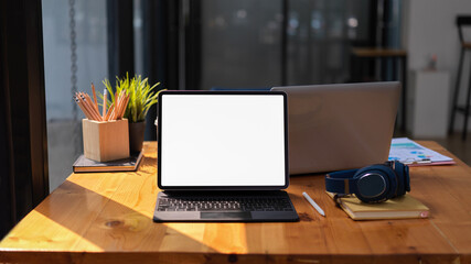 Workspace with digital tablet, camera and notebook in co-working space, clipping path