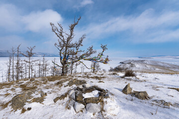 Ogoy island winter landscape. View of the mountains and frozen Lake Baikal on a winter day