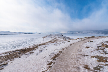 Ogoy island winter landscape. View of the mountains and frozen Lake Baikal on a winter day