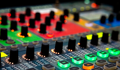 Sliders and buttons on Audio Mixing Desk at live event.