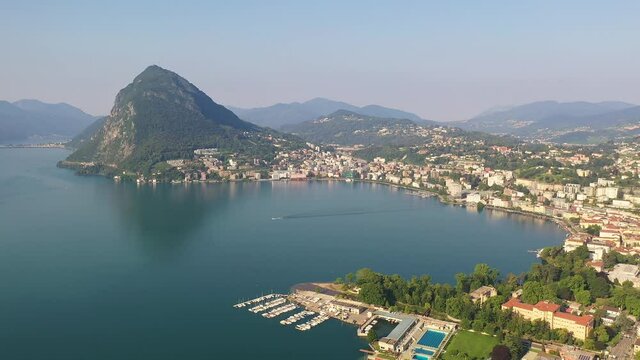 Aerial footage of the Lugano city by lake Lugano in Ticino in Switzerland