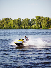Man speeding on jet ski on lake during summer vacation