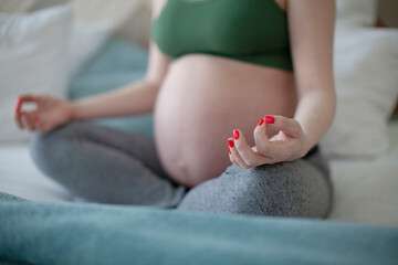 Obraz na płótnie Canvas Meditating on maternity. Close-up of woman meditating while on the floor