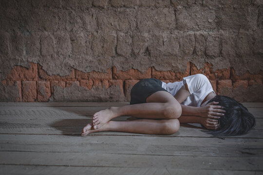 Poor people,homeless,A fearful child,Human Rights,homeless or victim lay down on the floor , concept for violence,beggar,