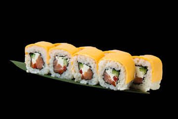 Rolls with salmon, chedar cheese, cream cheese, nori, cucumber and bell pepper, over black background with copy space.