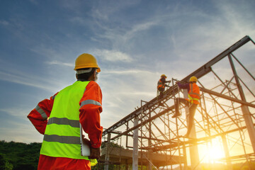 Asian construction worker control in the construction of roof structures on construction site and...