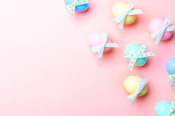 Easter background pink. Colourful egg with tape ribbon on pastel pink background in Happy Easter decoration. Flat lay, top view.