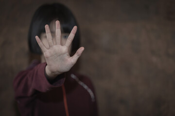 Kid girl showing hand signaling to stop useful to campaign against violence and pain. Stop abusing , terrified , A fearful child, human rights - obrazy, fototapety, plakaty