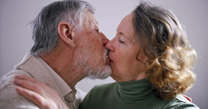 kiss an elderly couple. an old husband and wife kiss each other on the lips. eternal love. 